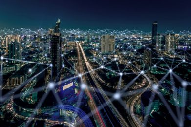 time-lapsed photo of a large downtown area at night, with a web of lights added onto the photo