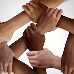Racism and human civil rights as diverse people of different ethnicity holding hands together as a social solidarity concept of a multiracial group working as united partners.